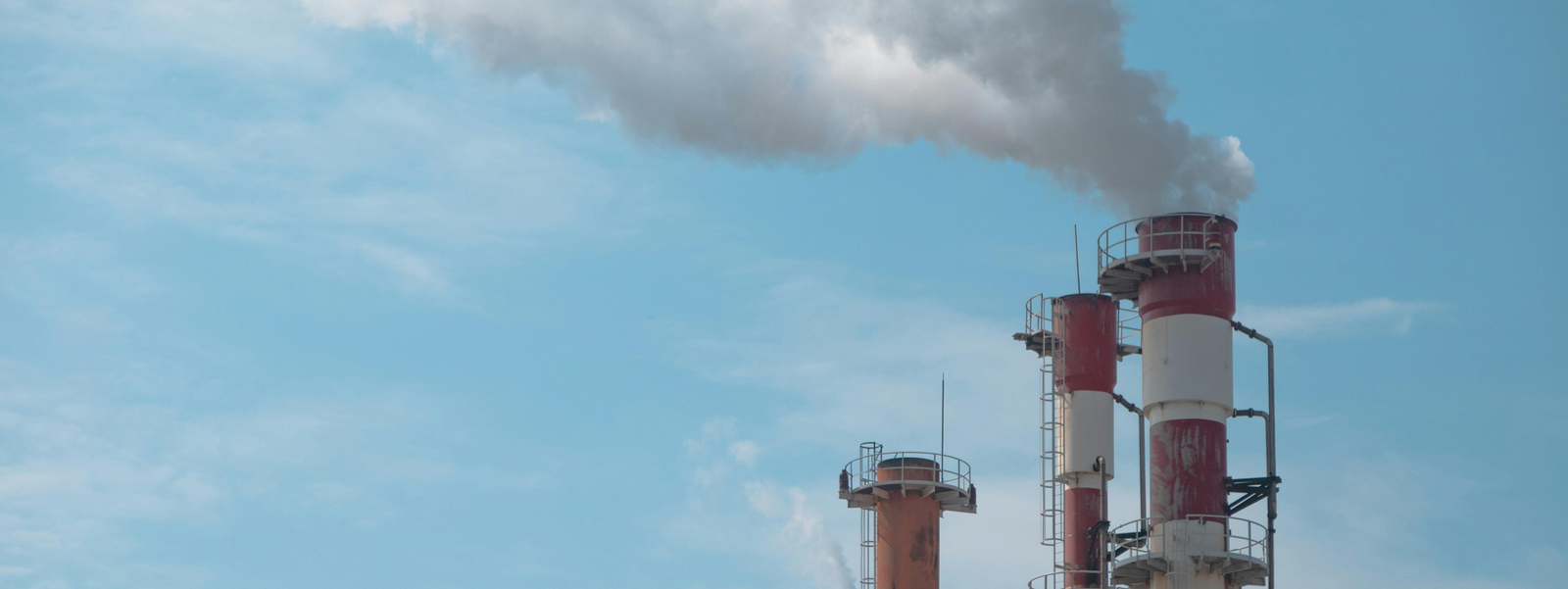 Factory chimneys releasing white smoke